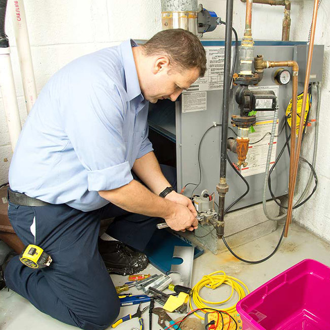 man-repairing-furnace-repair-wilmington-oh